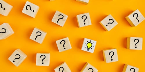 light bulb in a field of question marks to represent finally solving the digital workbook creation problem for wholesale B2B