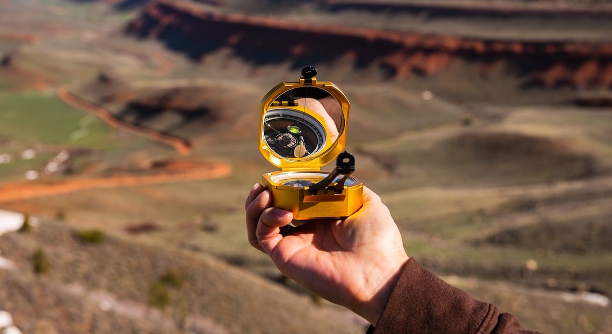 Person holding a Brunton compass