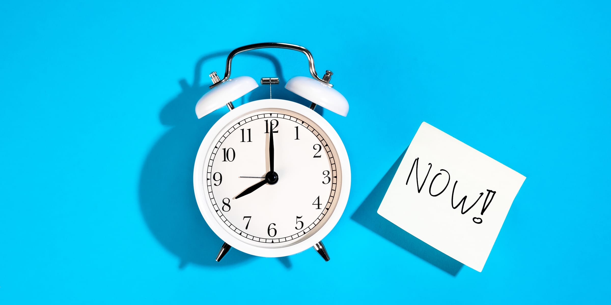 Alarm clock with note that says now is the best time to upgrade your B2B