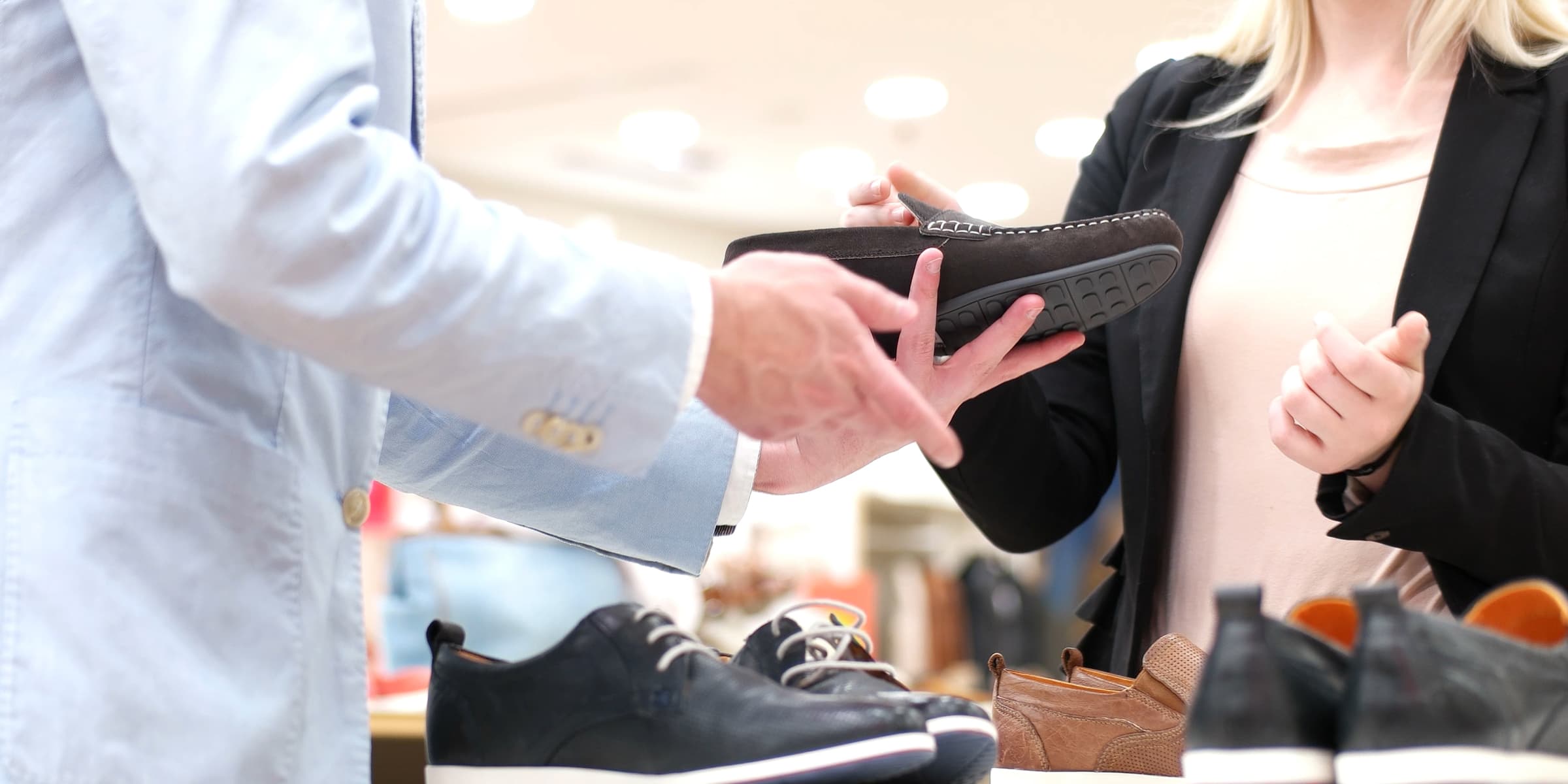 Retail person holding shoe